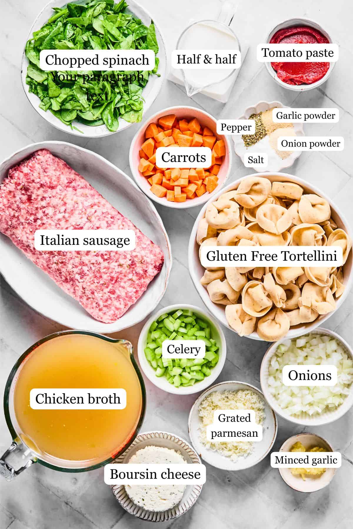 ingredients on a white surface including spinach, carrots, italian sausage, tortellini, seasonings, half and half, tomato paste, boursin cheese, chicken broth, celery, onions, and garlic 