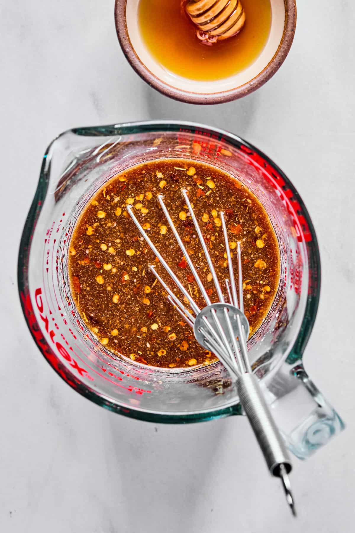 Stir fry sauce ingredients in a glass measuring cup whisked together.