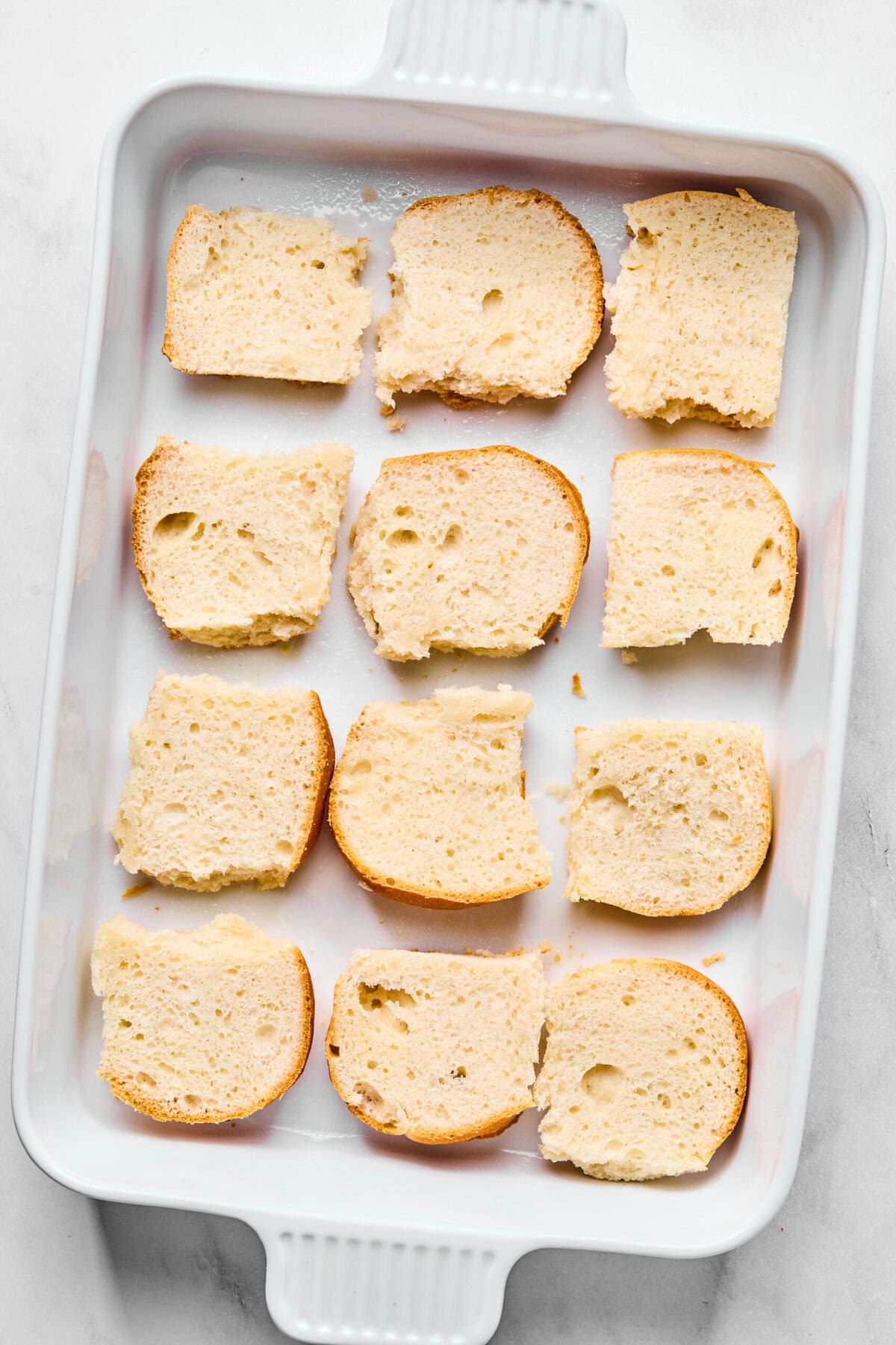 the bottoms of rolls lined up in a casserole dish