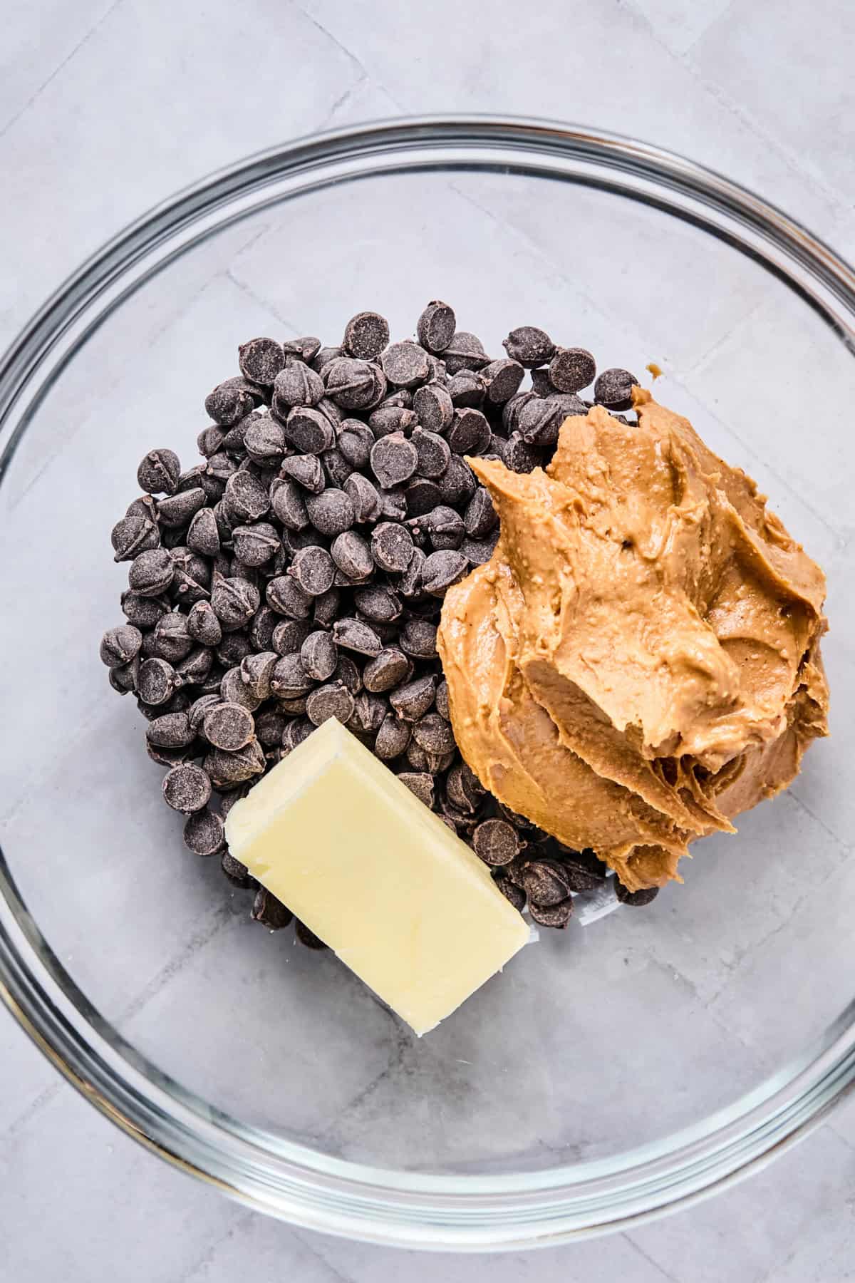 Chocolate chips, peanut butter, and butter in a microwave-safe bowl.