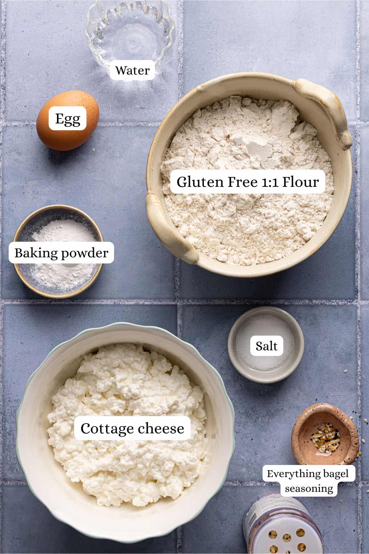 Cottage cheese bagels recipe ingredients laid out in nesting bowls and labeled.