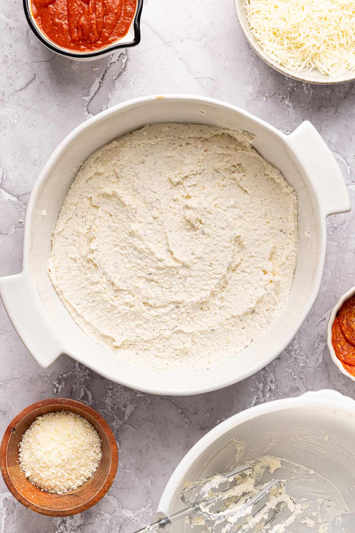 High protein pizza dip mixture spread out evenly in a dish.