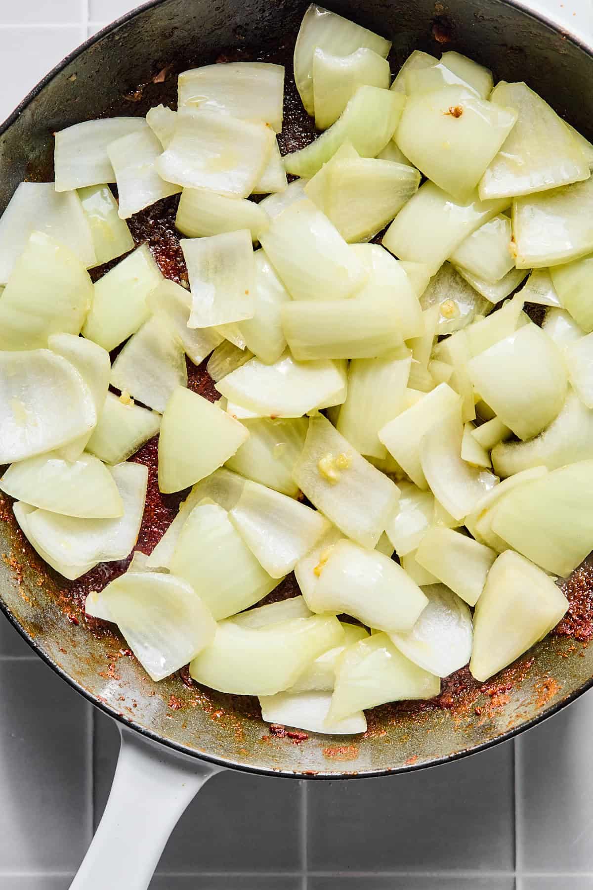 Onion and garlic added to the skillet with the stew meat.