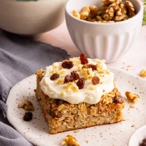 carrot cake baked oats with cream cheese frosting on a plate