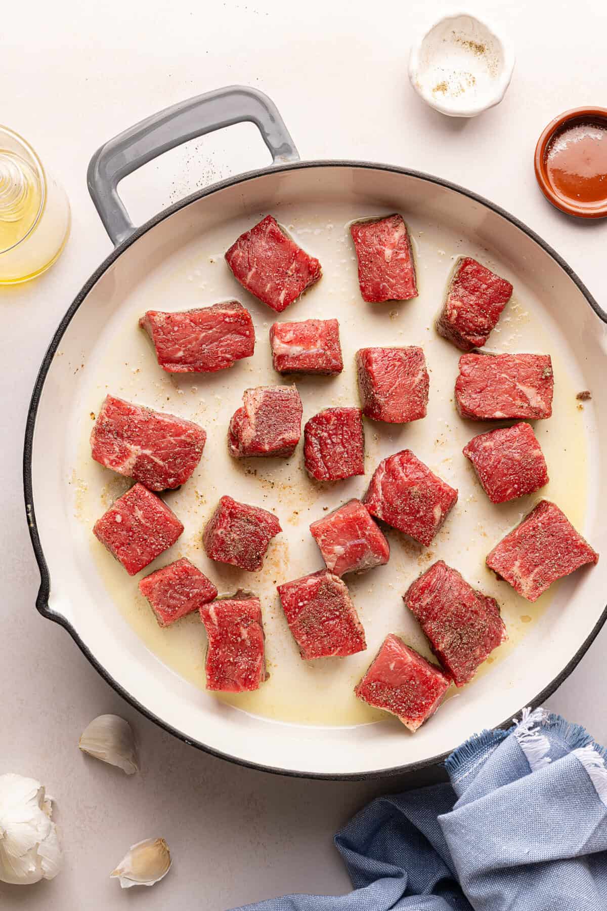 steak bites searing in a pan