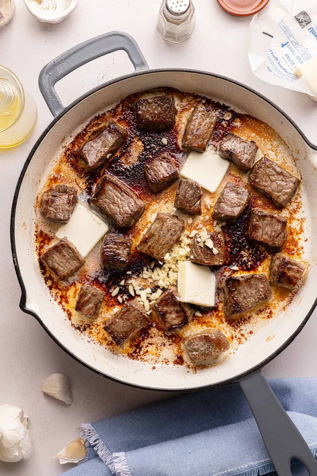 steak bites in a pan with butter