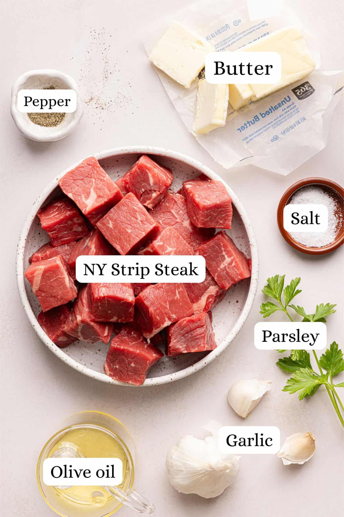ingredients for garlic butter steak bites in nesting bowls