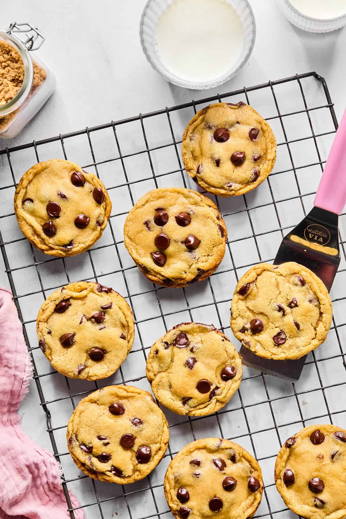 cookies on a cooling rack with a pink spatula