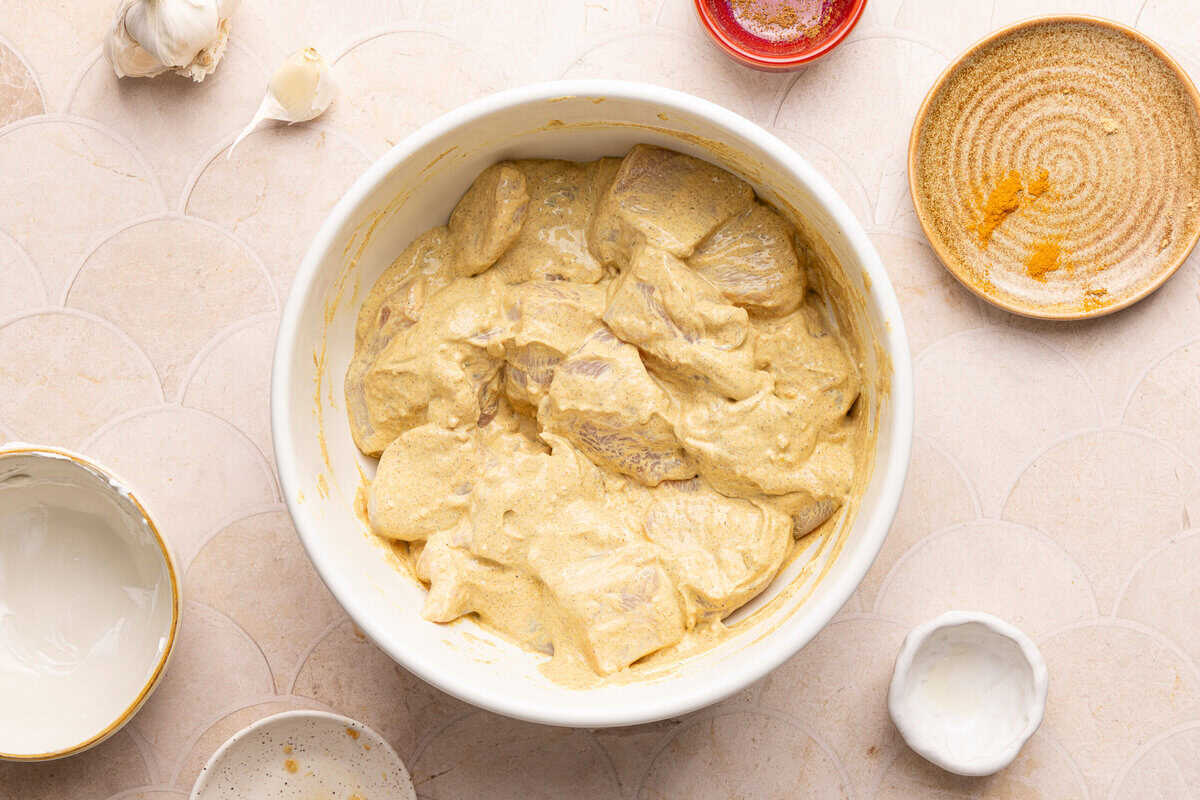 chicken marinating in a bowl
