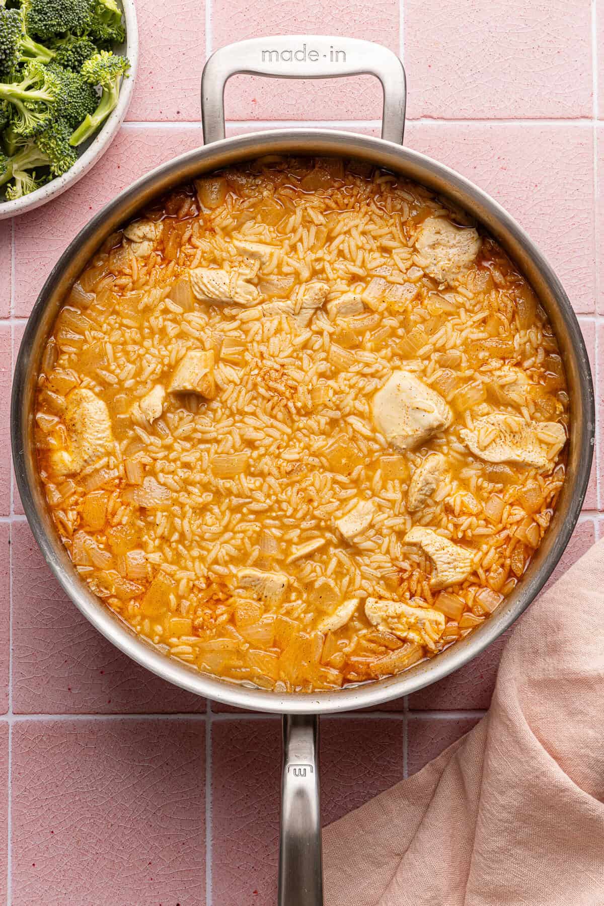 chicken, rice, broth and seasonings in a pan