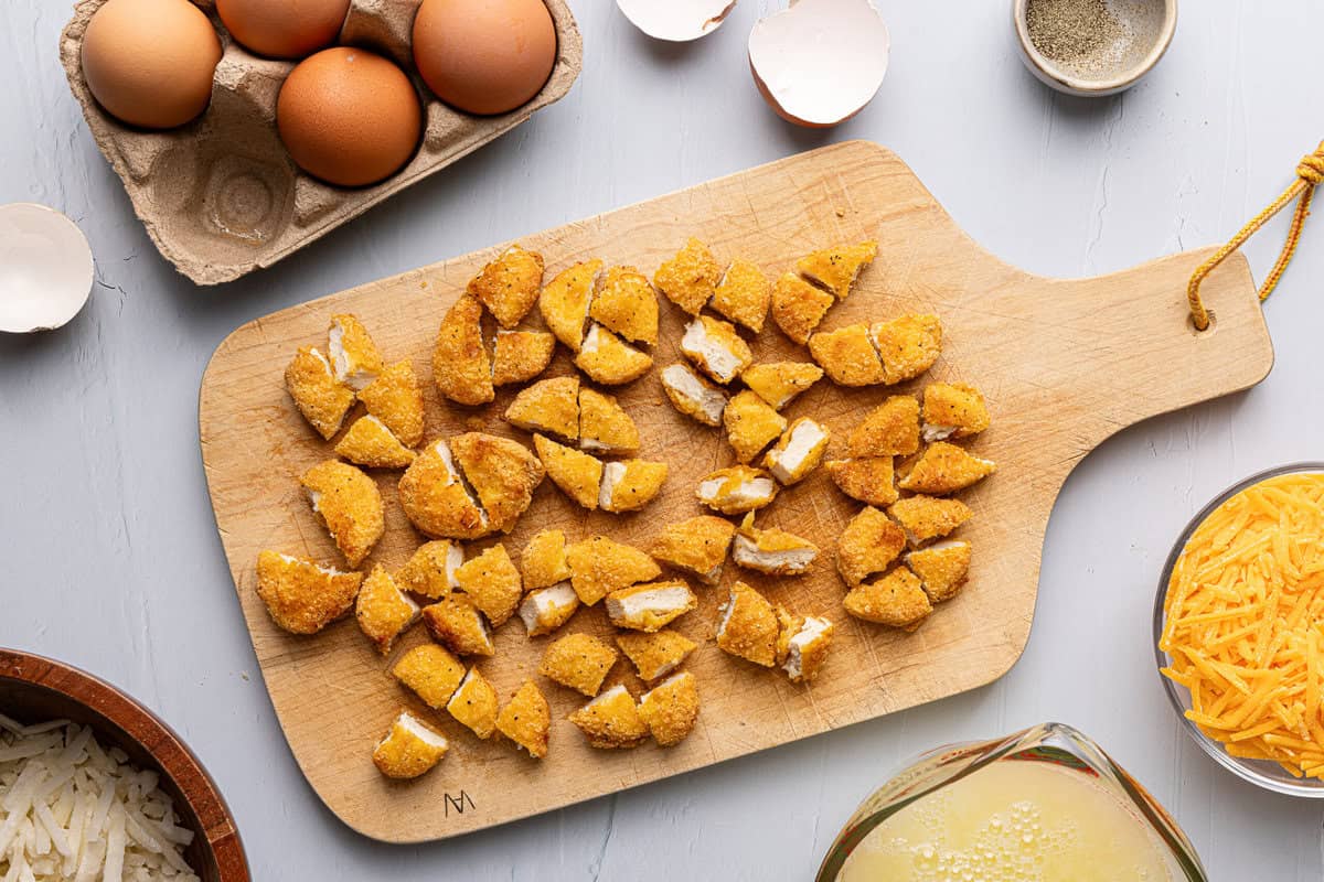 chopped up chicken nuggets on a cutting board