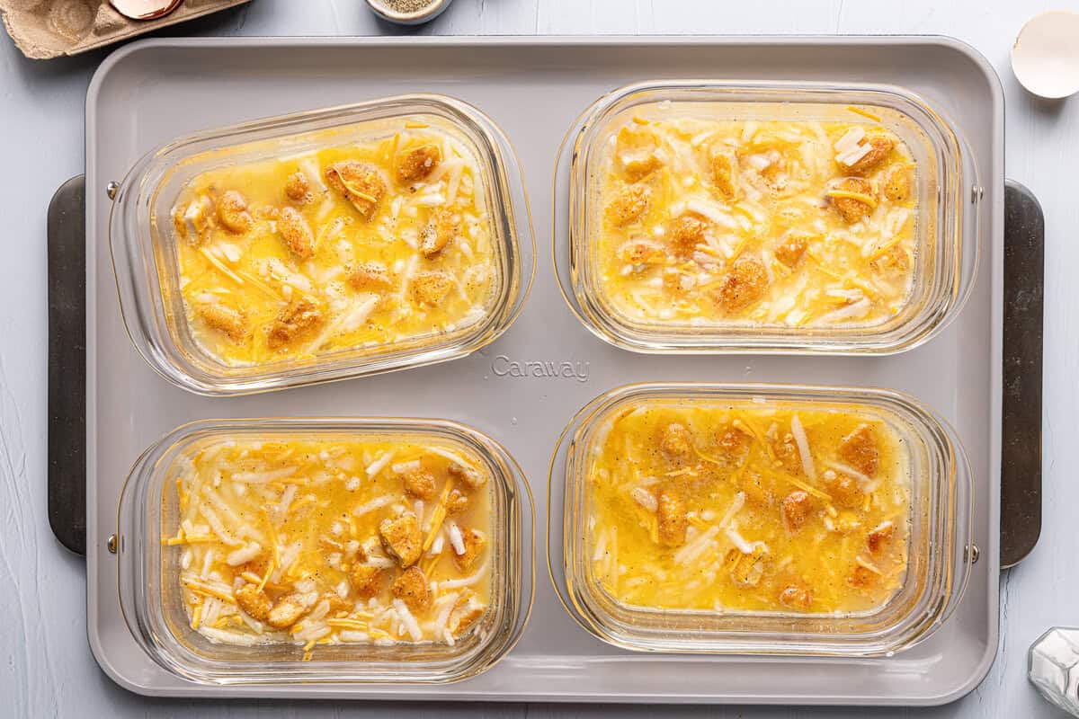 meal prep breakfast casseroles on a baking sheet, uncooked