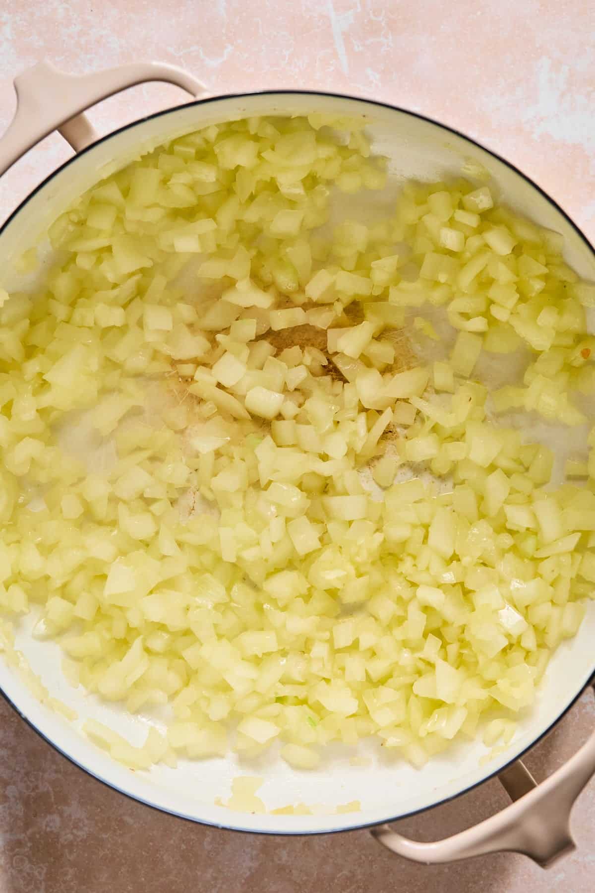 Sautéing onion and garlic in a Dutch Oven.