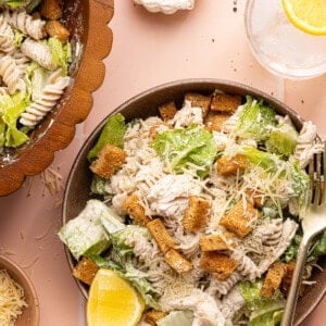 chicken caesar pasta salad in a bowl with a silver fork