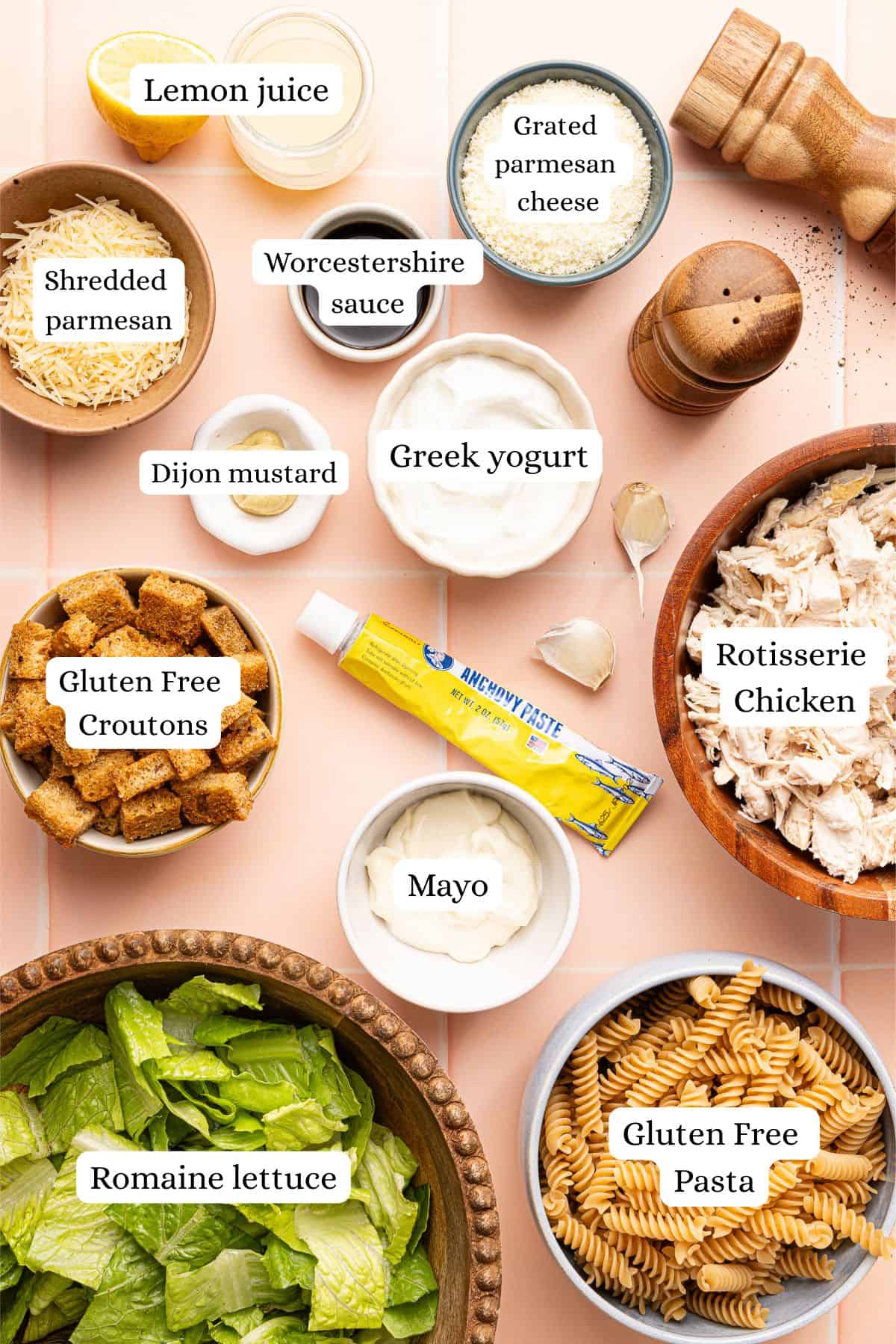 ingredients for chicken caesar pasta salad in nesting bowls