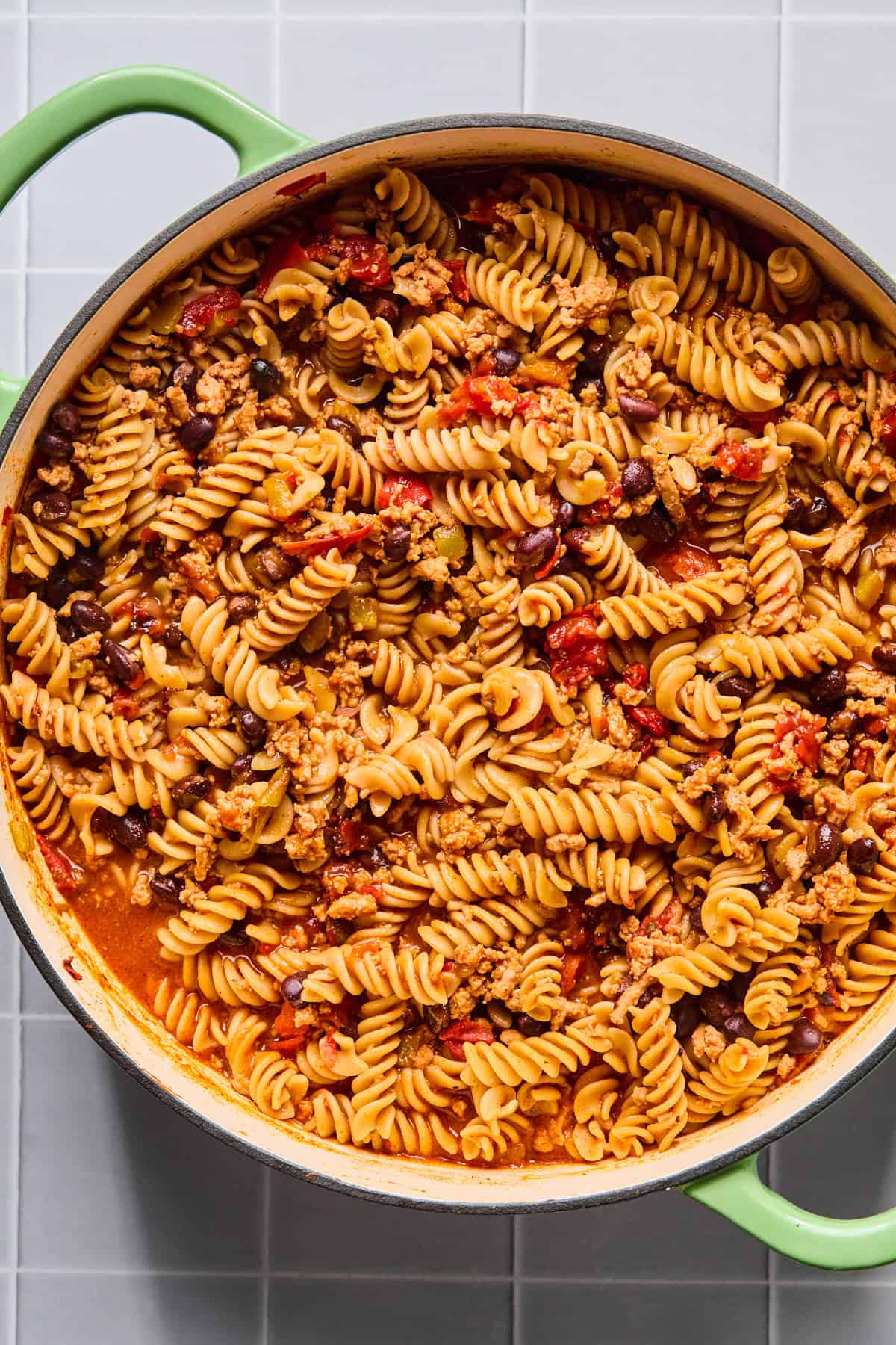 One pot taco pasta simmering in broth as the pasta cooks and absorbs the sauce.