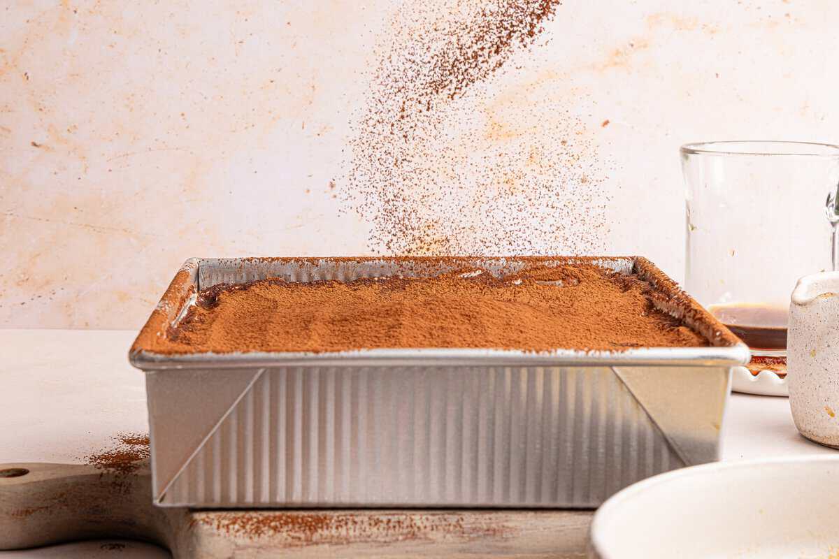 cocoa powder being dusted on a pan