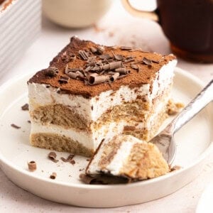 a slice of gluten free tiramisu with a fork taking a bite