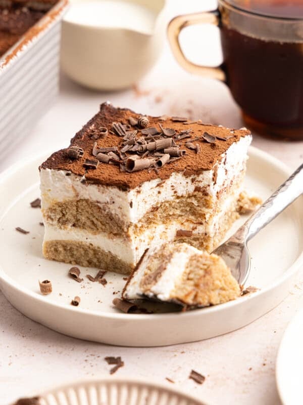 a slice of gluten free tiramisu with a fork taking a bite