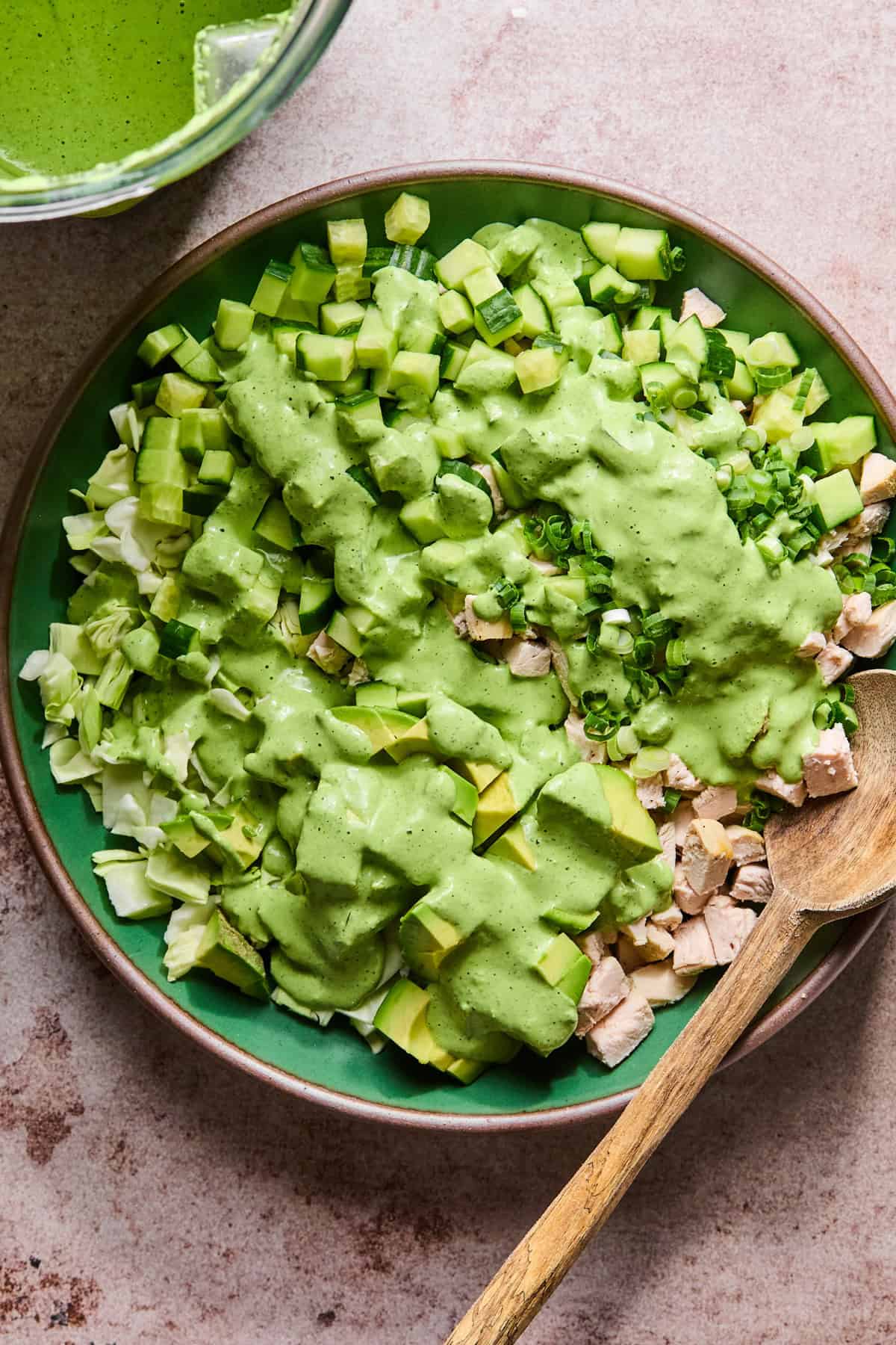 green goddess salad with dressing on top