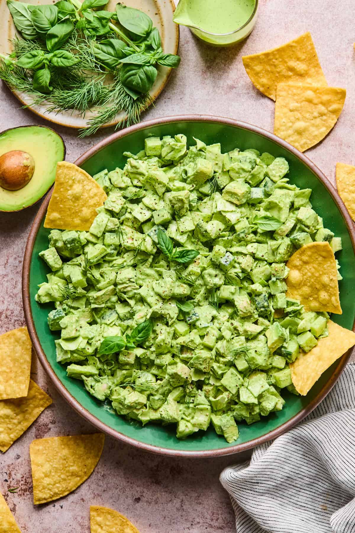 Green goddess chicken salad in a bowl with chips and avocado 
