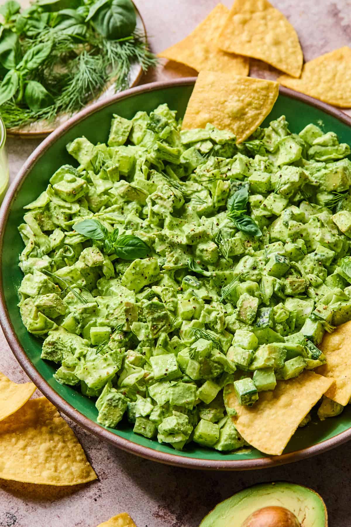 A side view of green goddess chicken salad with chips stuck into it