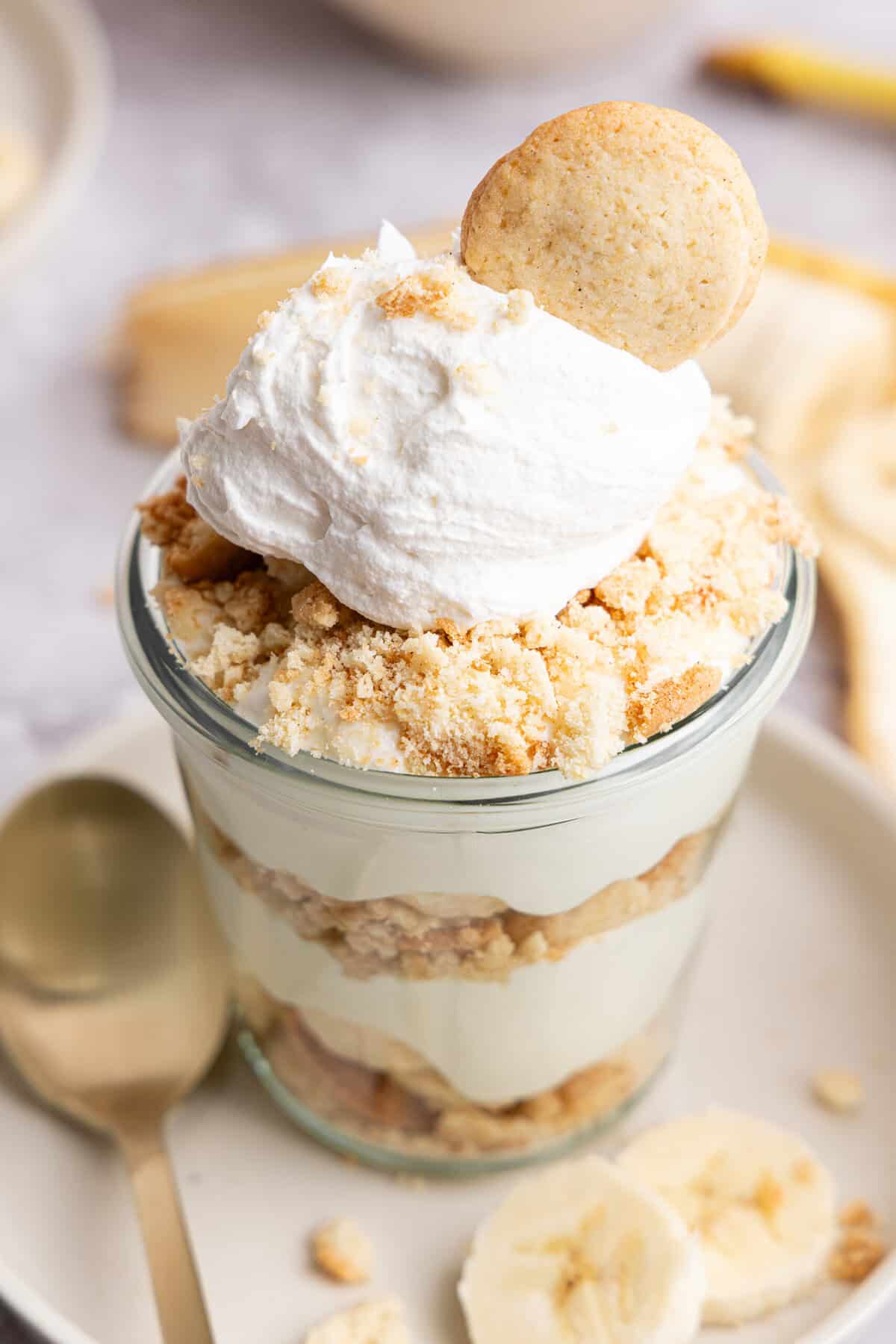 a close up side view of a glass cup of banana pudding