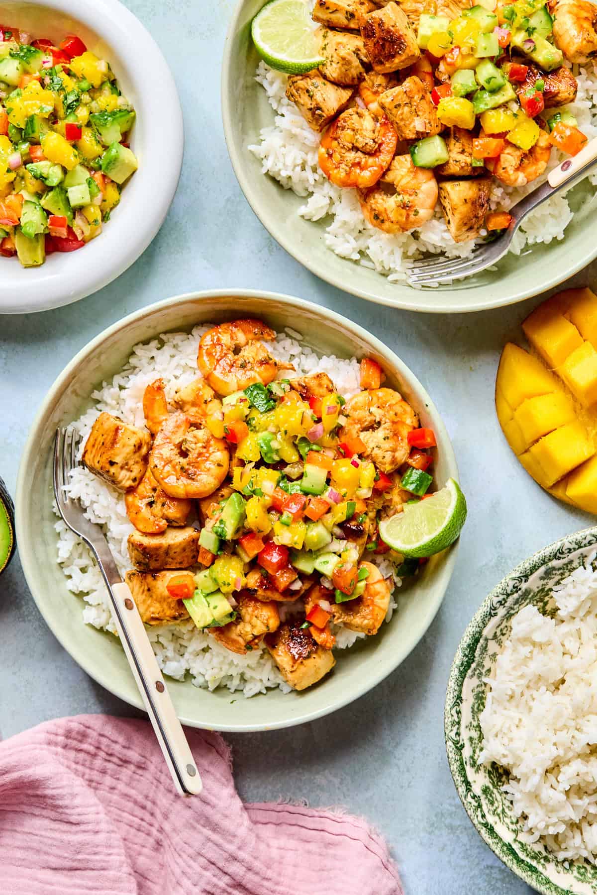 2 bowls of cilantro lime chicken and shrimp with rice and salsa