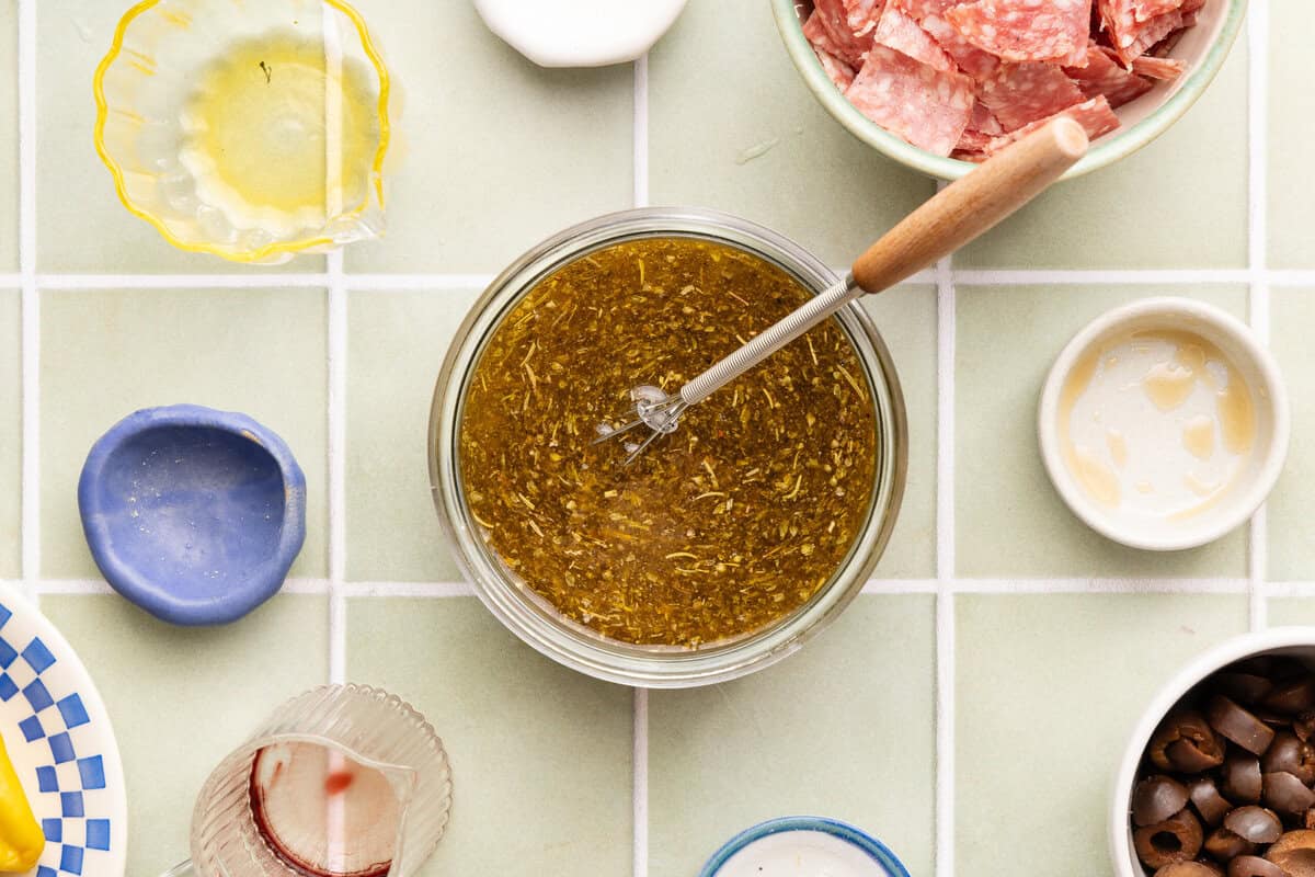 Homemade gluten-free Italian dressing ingredients whisked together in a bowl until smooth and combined.