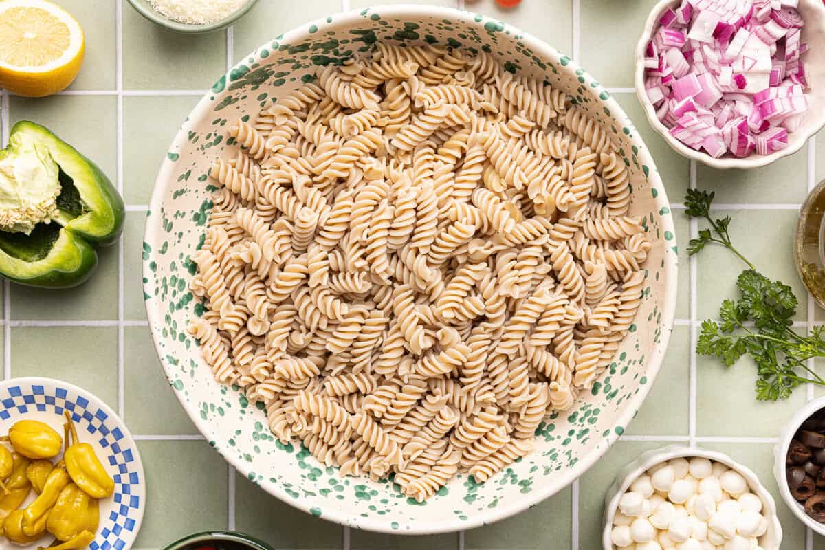 Cooked gluten-free fusilli pasta rinsed with cold water, drained, and in large mixing bowl.