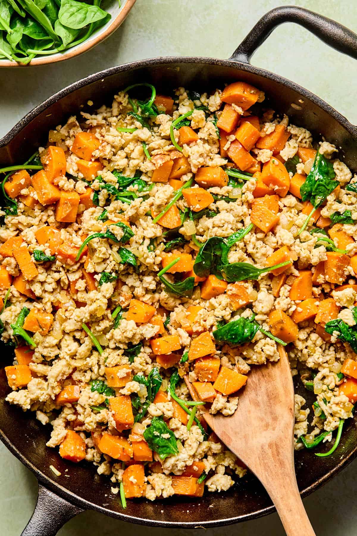 sweet potato turkey skillet with a wooden spoon