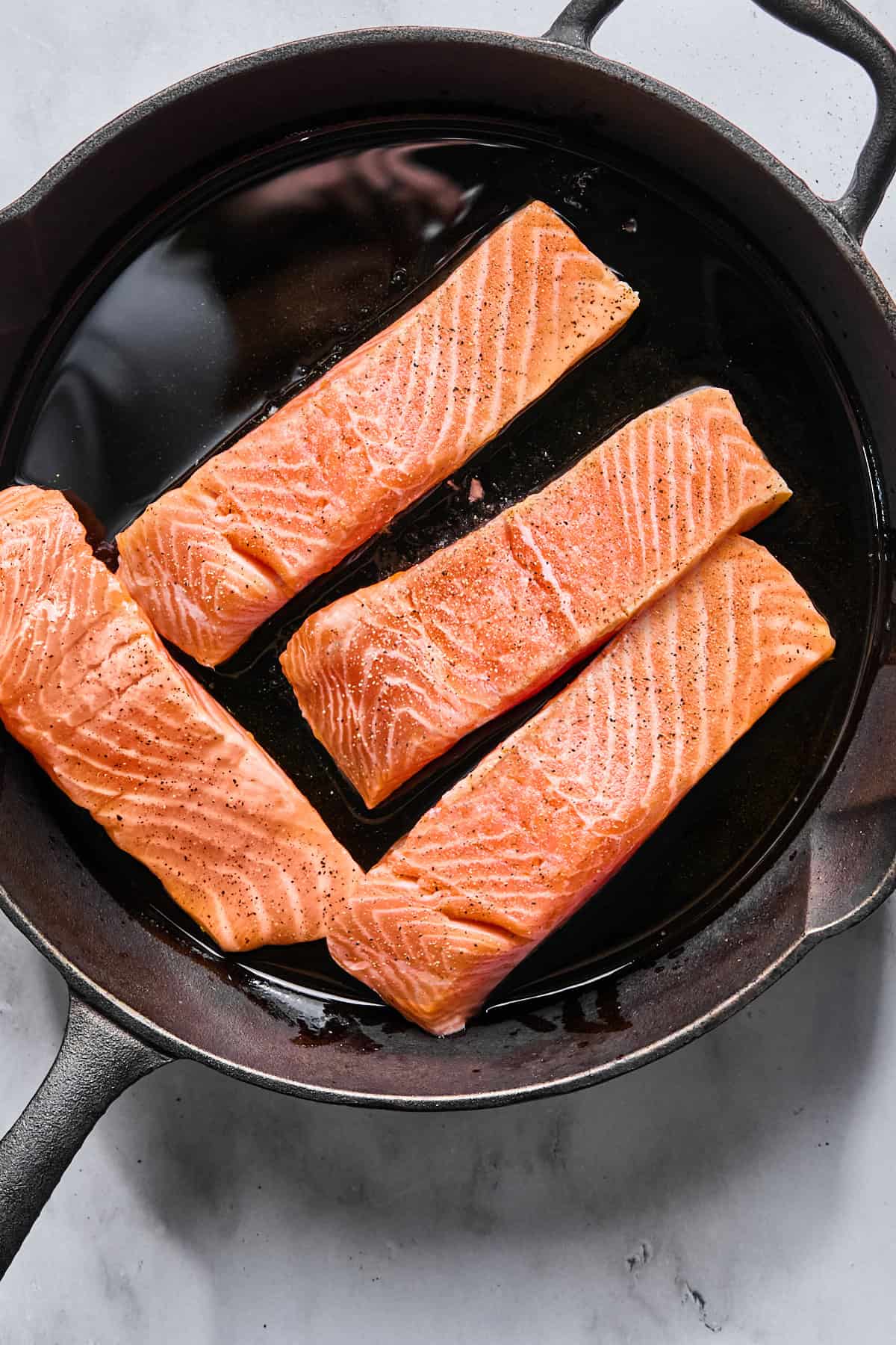salmon fillets in a cast iron skillet