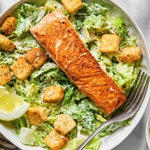 salmon caesar salad in a bowl