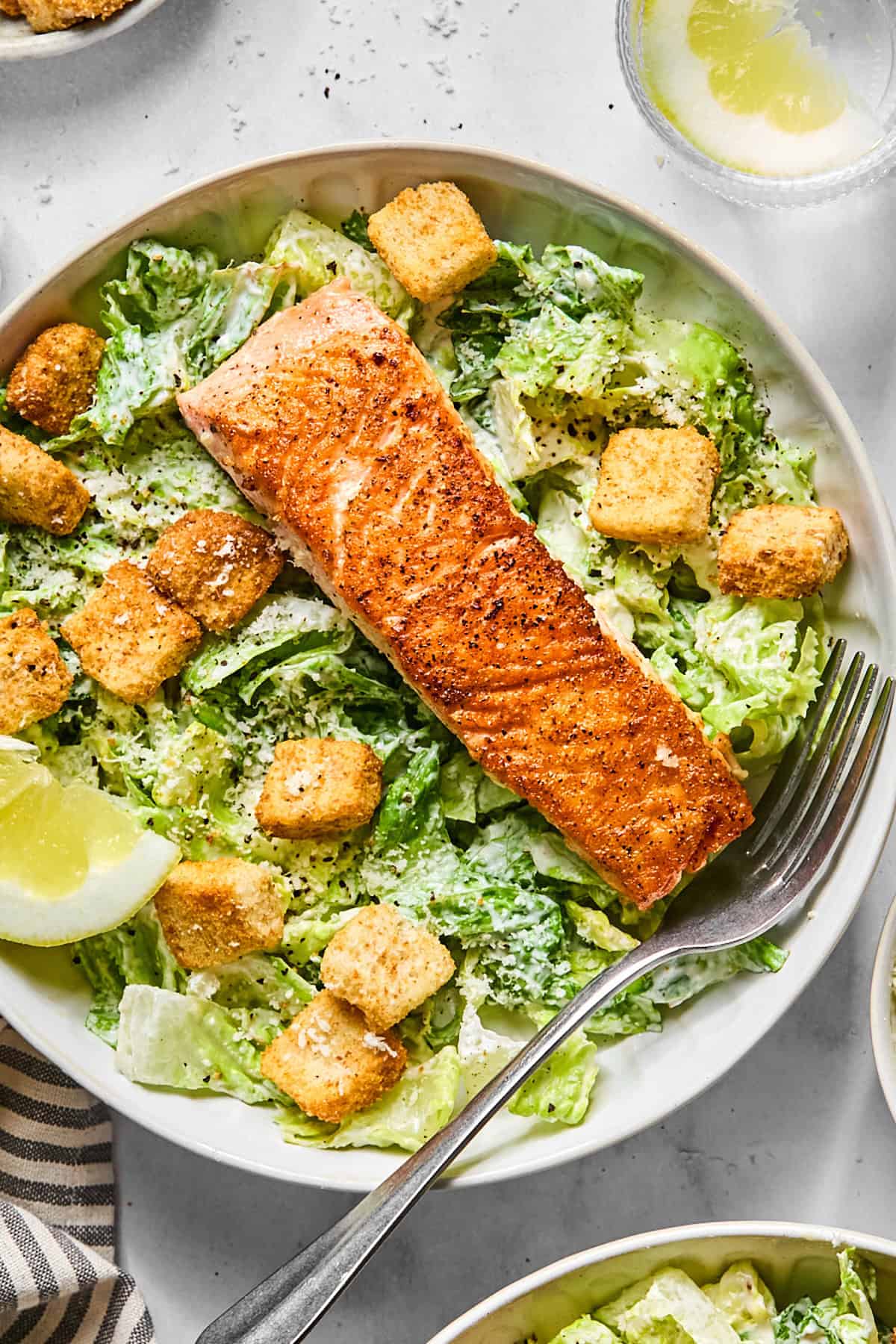 salmon caesar salad in a bowl