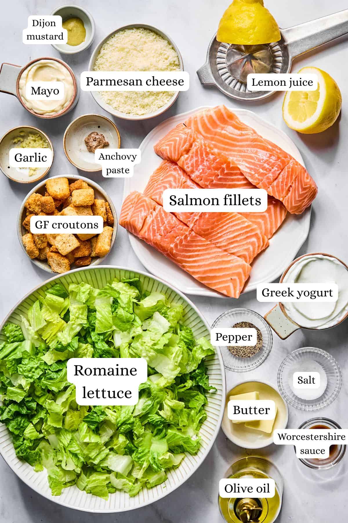 salmon caesar salad ingredients in nesting bowls