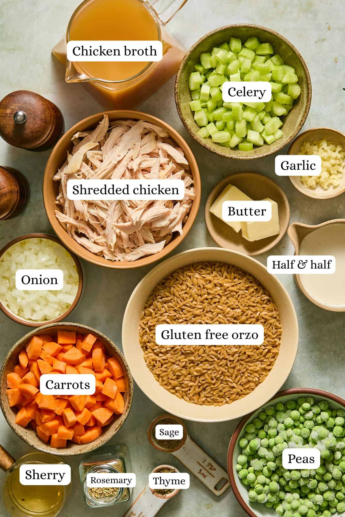 Chicken pot pie orzo ingredients arranged in labeled nesting bowls on a countertop.