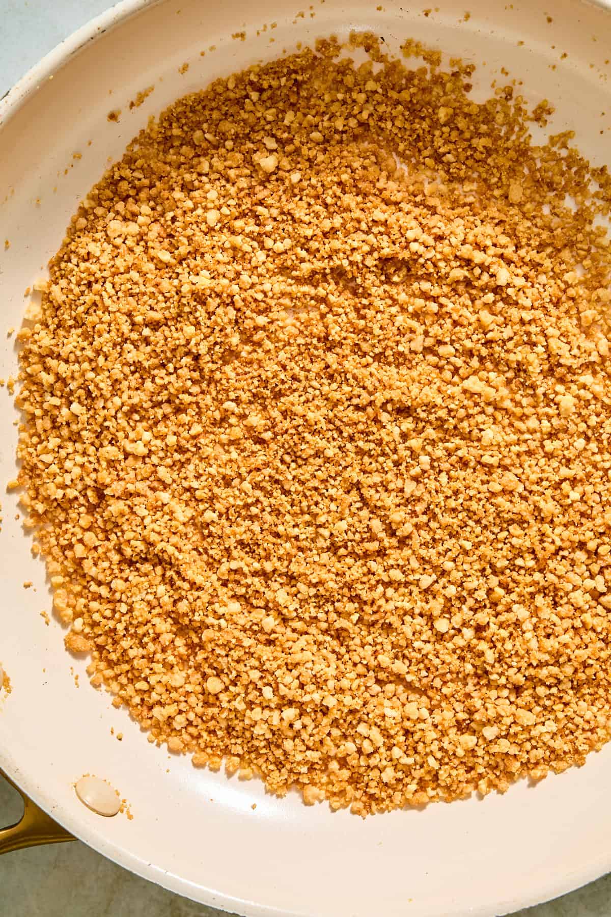 Gluten free panko toasting in butter in a skillet until golden brown