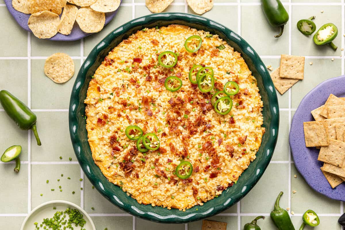 Baked jalapeno popper dip with a golden brown panko topping and bubbling edges in a round green dish