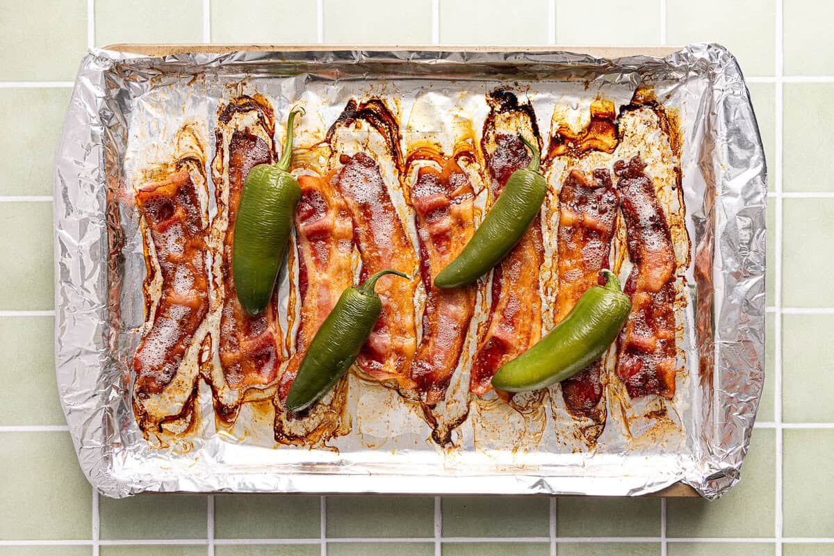 Bacon and jalapenos roasted on a foil-lined baking sheet