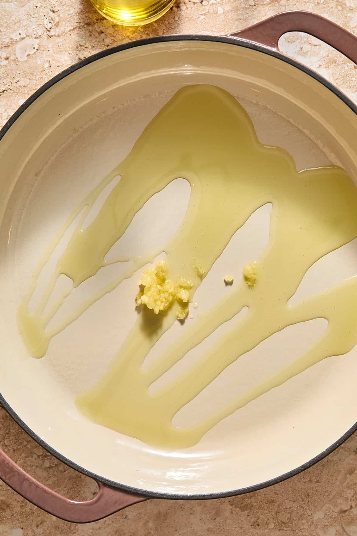 A pan with olive oil and garlic.