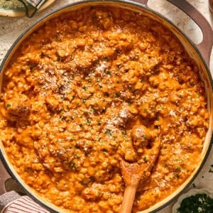gluten free spaghettios and meatballs in a skillet with a wooden spoon
