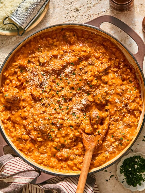 gluten free spaghettios and meatballs in a skillet with a wooden spoon