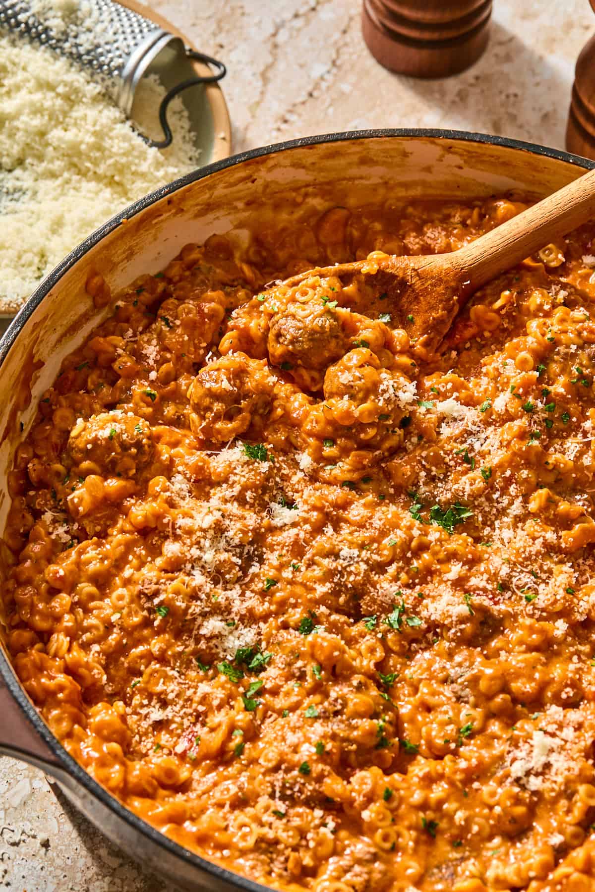 The finished gluten-free spaghettiOs and mini meatballs dish topped with parmesan and parsley.