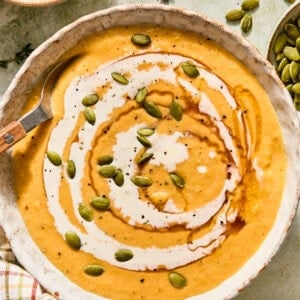 boursin butternut squash soup with hot honey and pumpkin seeds with a cream swirl