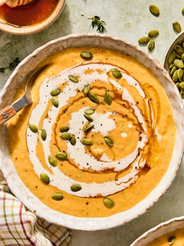 boursin butternut squash soup with hot honey and pumpkin seeds with a cream swirl