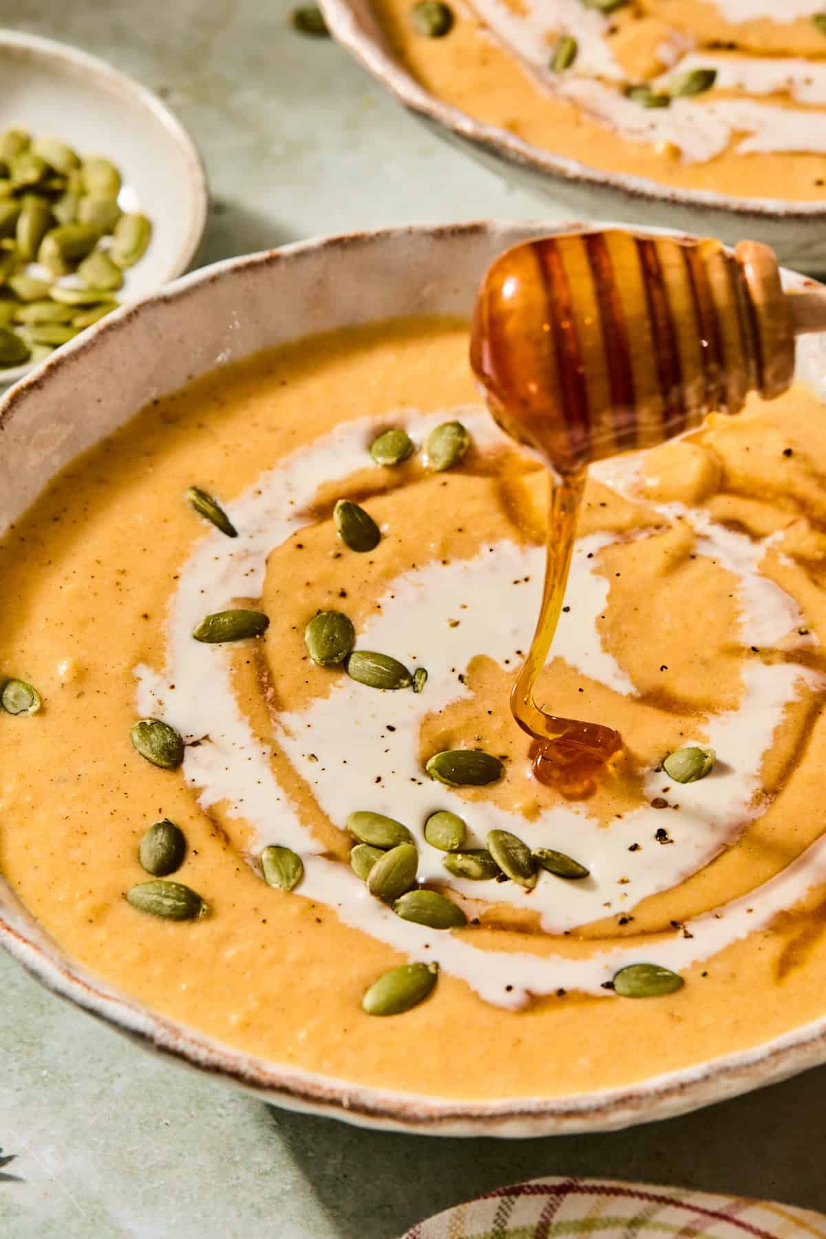 Drizzling hot honey onto butternut squash soup with boursin.