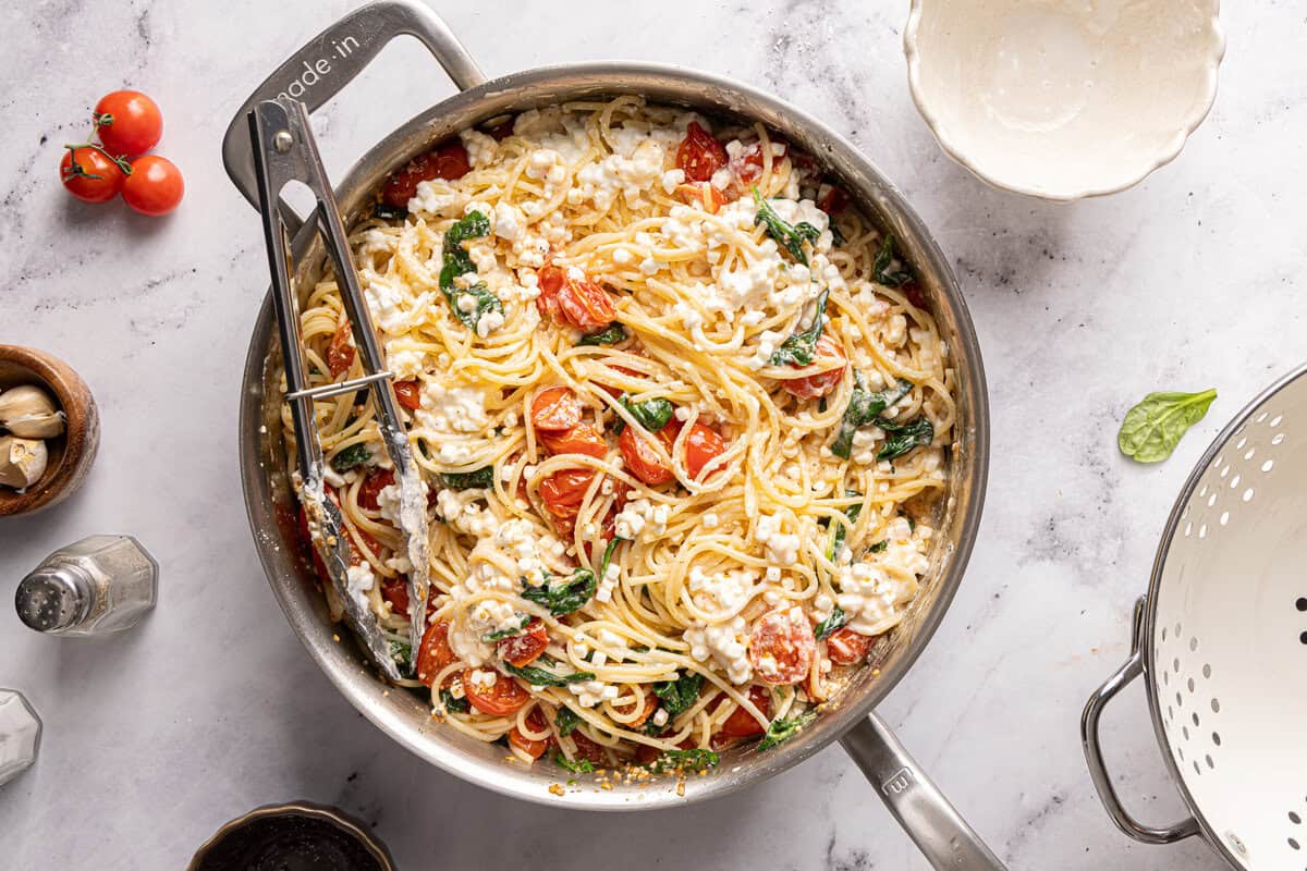 A pot filled with all the ingredients for cottage cheese pasta before tossing.
