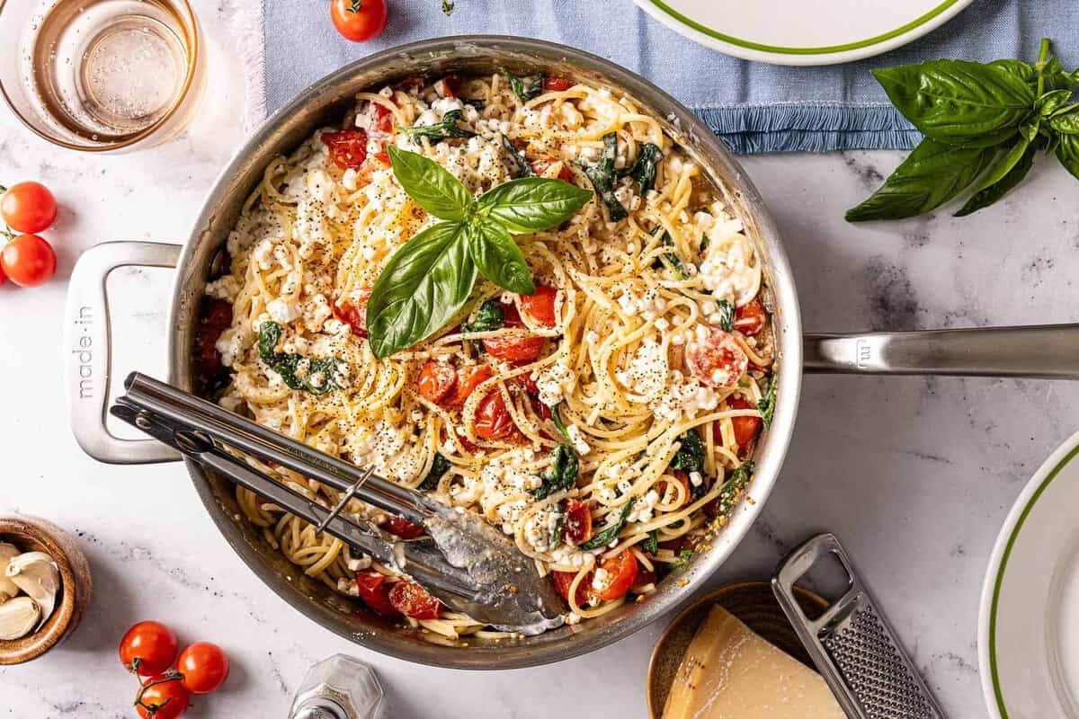 cottage cheese pasta in a skillet with basil on top