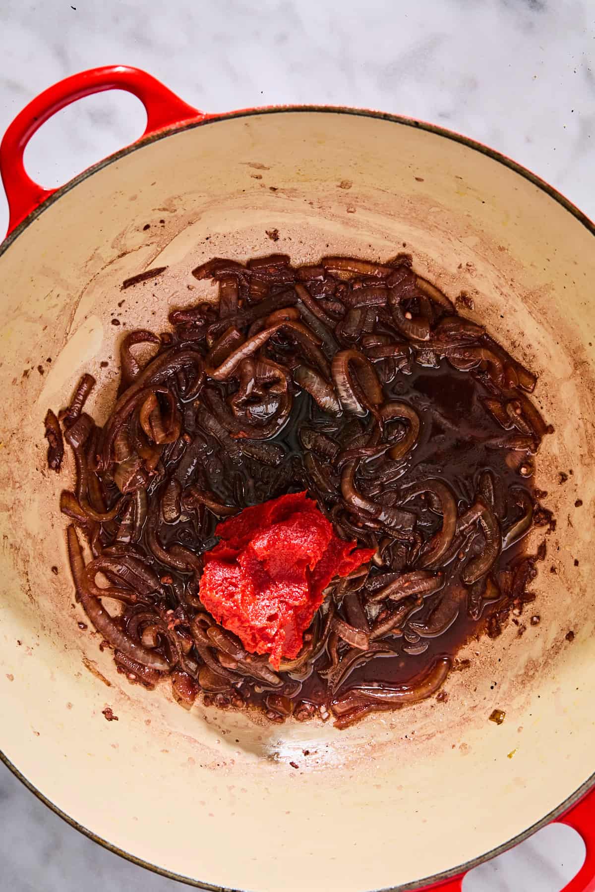 Tomato paste added to the deglazed pot.